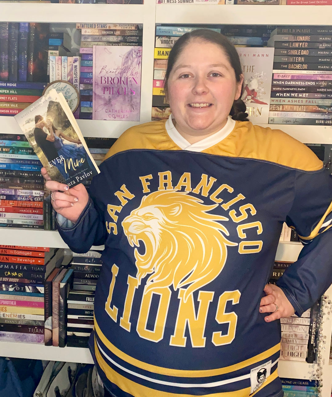 a woman in a hockey jersey holding a book