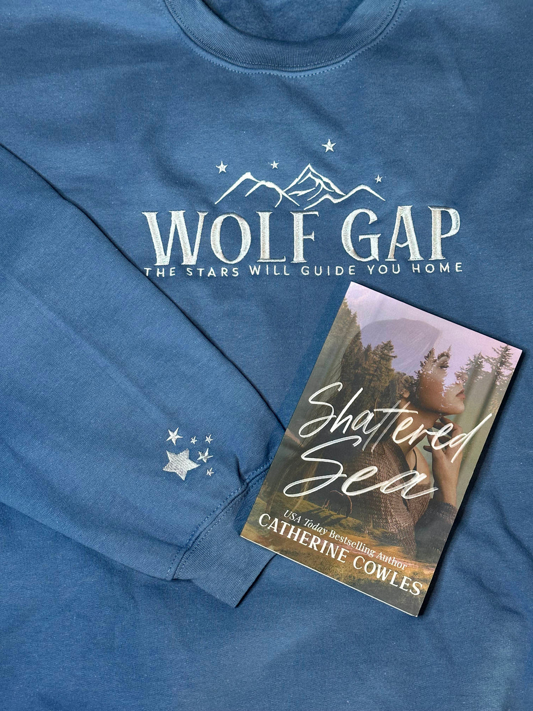 a book laying on top of a blue shirt